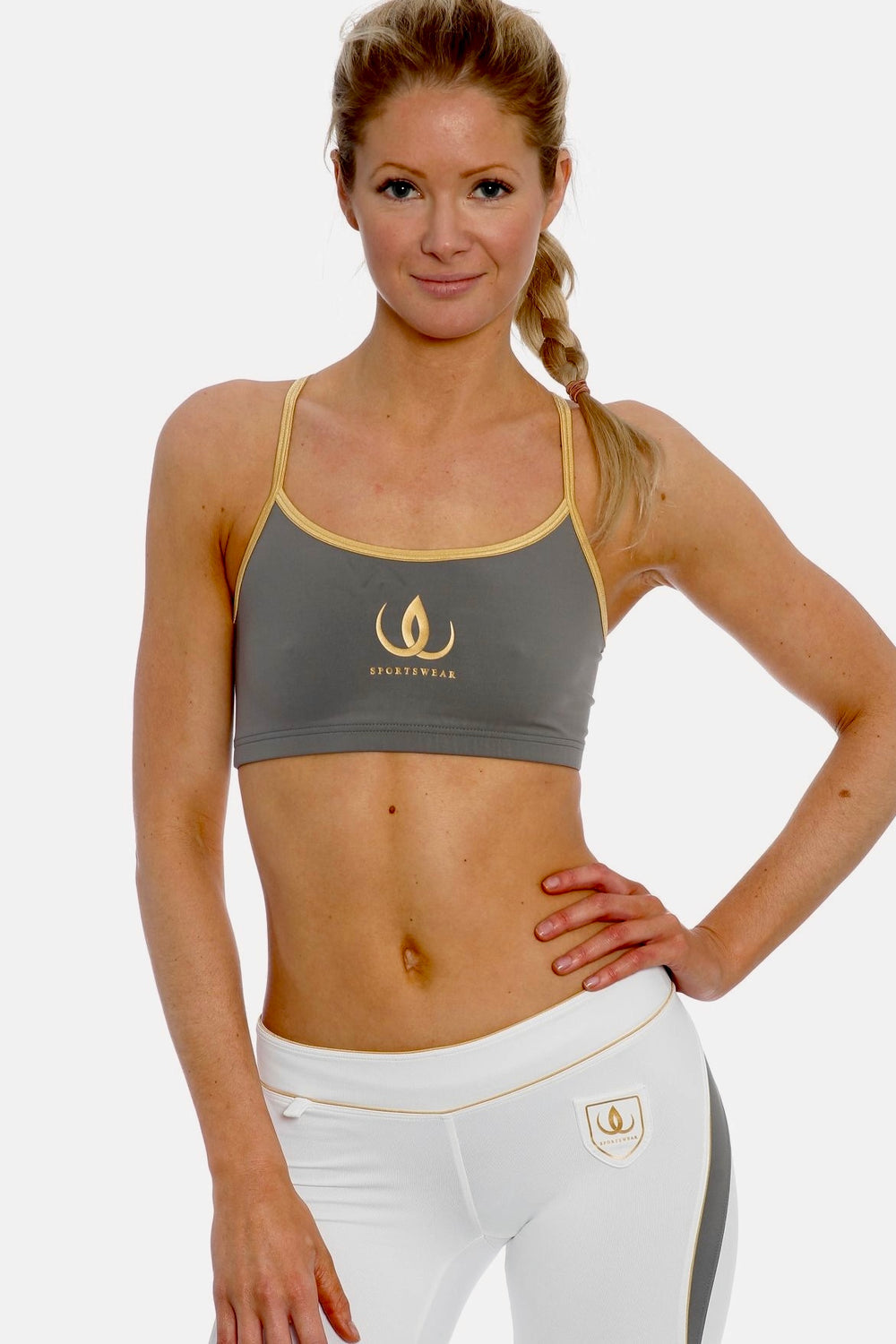 Grey training top with gold-coloured straps and gold logo, worn with white tights with a grey panel.