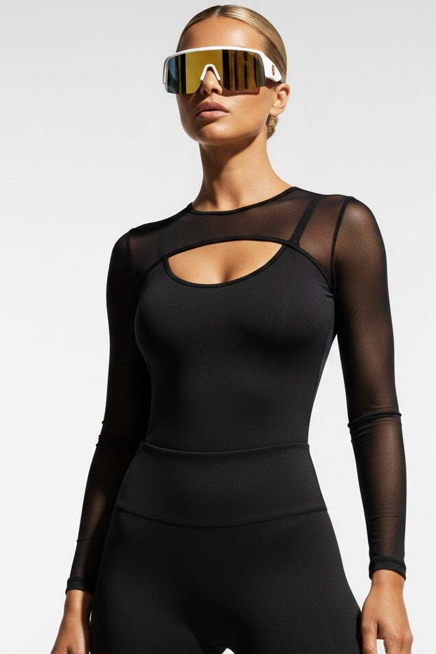Black long-sleeved top with sheer mesh over the shoulders and a narrow opening below the bust.