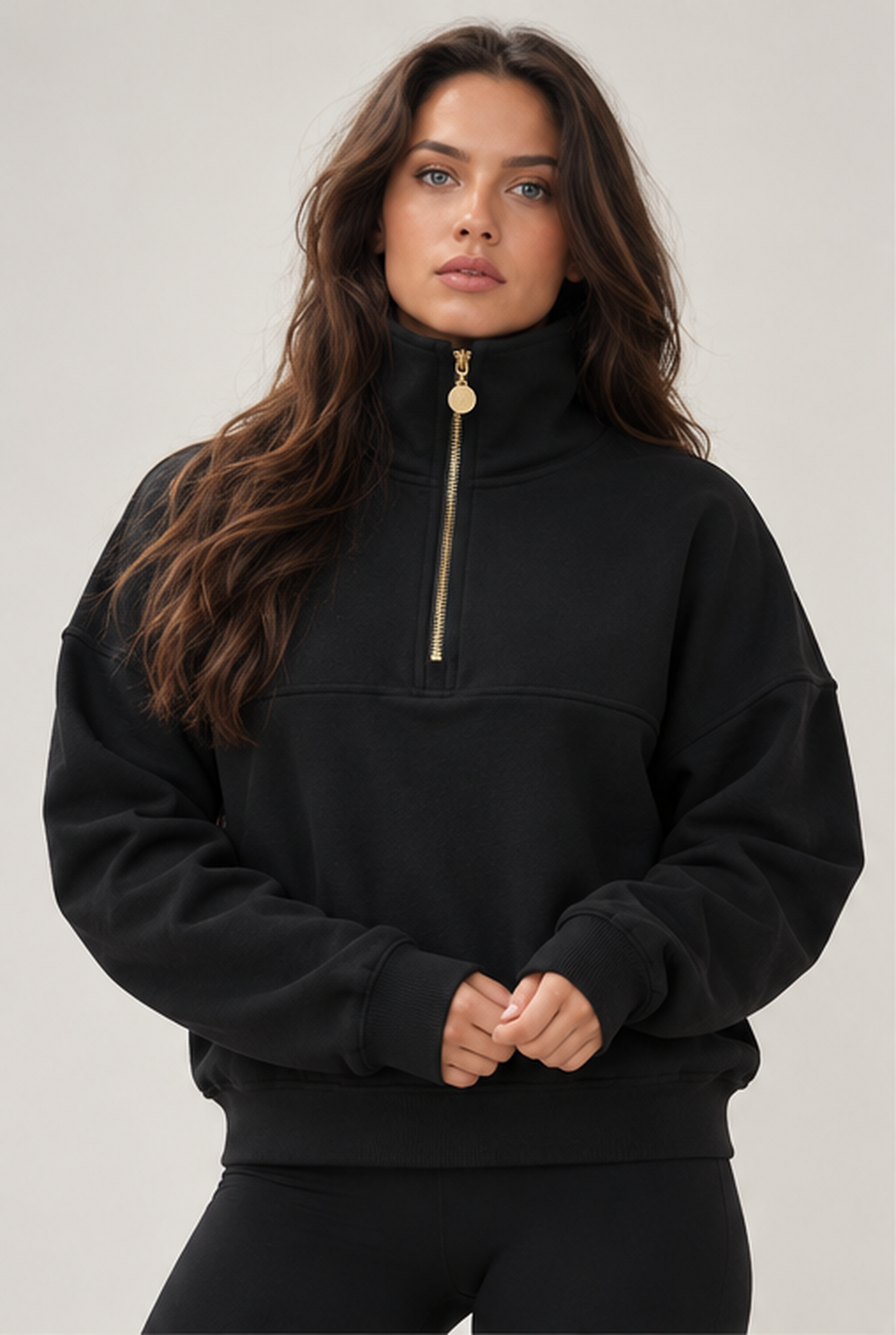 Edge Cozy Half Zip Sweater in black from the front, high collar and a gold-coloured zip down to the chest.