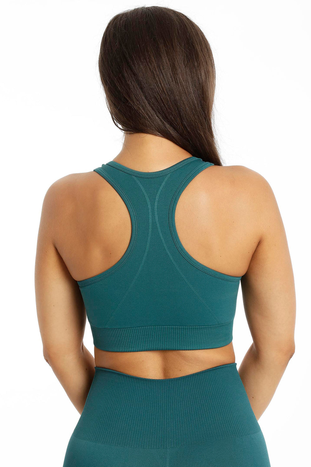 Back of the green top, with narrow straps meeting at the centre of the back and a ribbed hem.