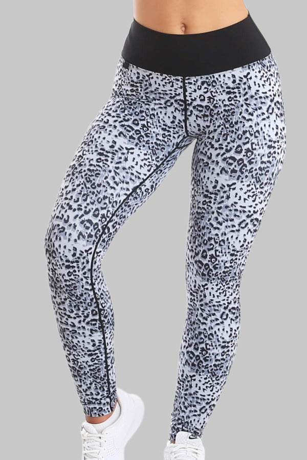 The tights have a black and grey spotted pattern over the whole leg and a wide black waistband.