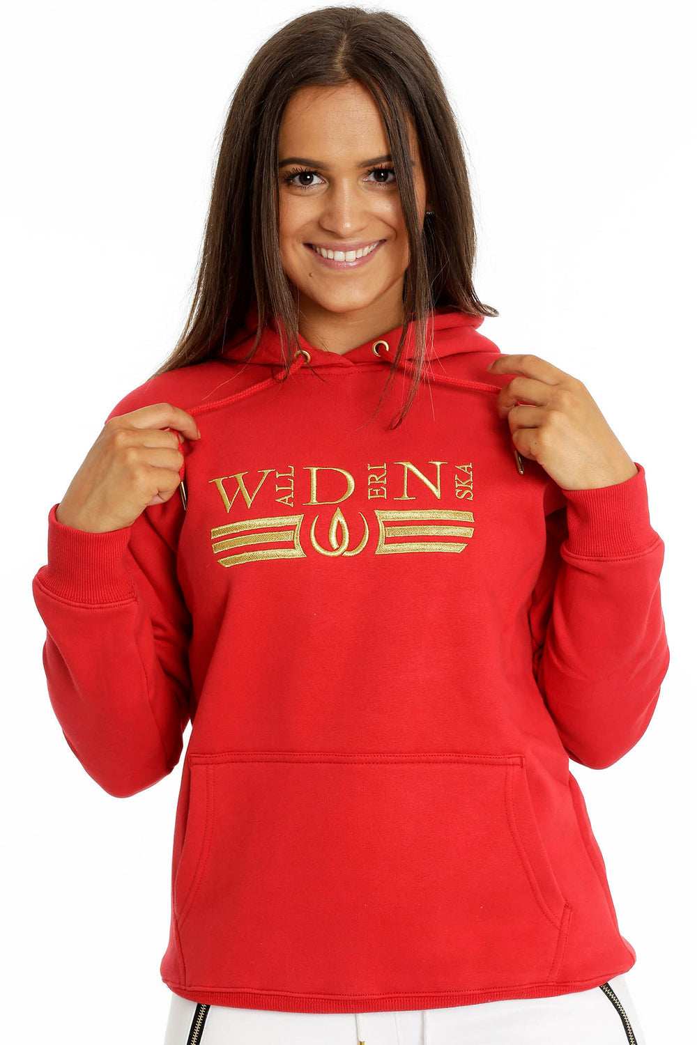 The hood's drawstrings are held in the hand. The gold embroidery runs across the chest of the red hoodie.