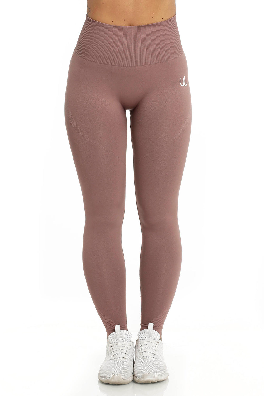 A white logo sits at the hip of the rose-brown tights, the waistband ribbed and high.