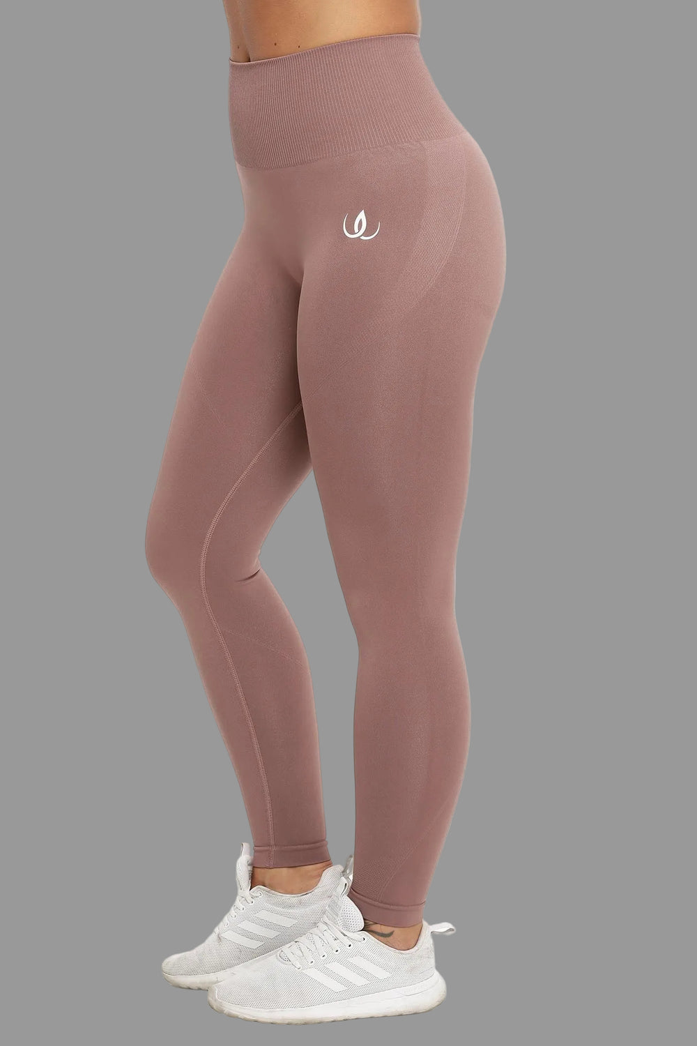 Muted rose-brown tights with a wide ribbed waistband and a white logo on the thigh.