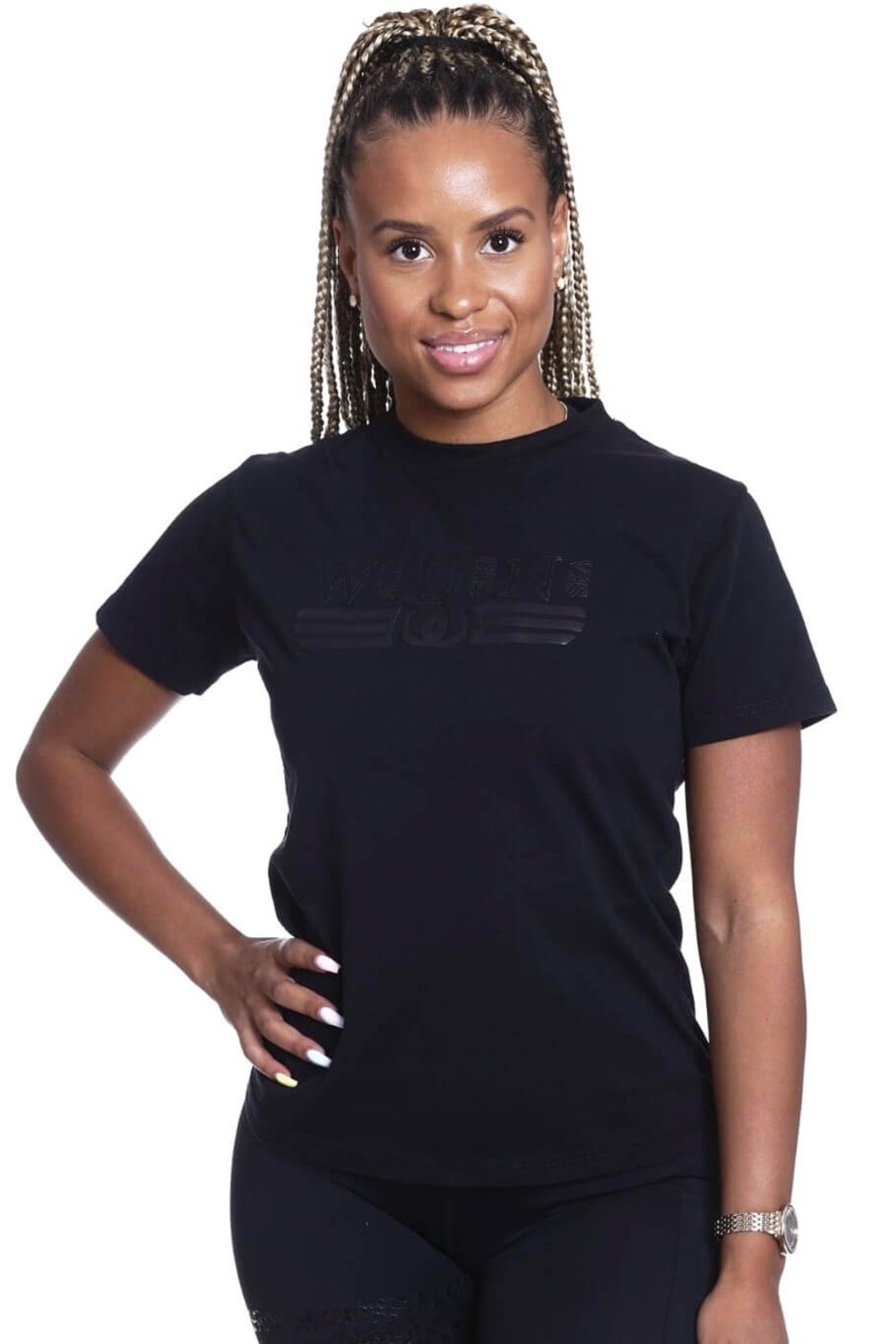 The model stands with her hand on her hip in the black top with a tone-on-tone logo.