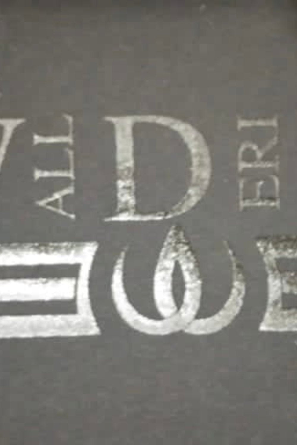 The logo printed in the same dark tone as the fabric, with letters and two lines around the symbol.