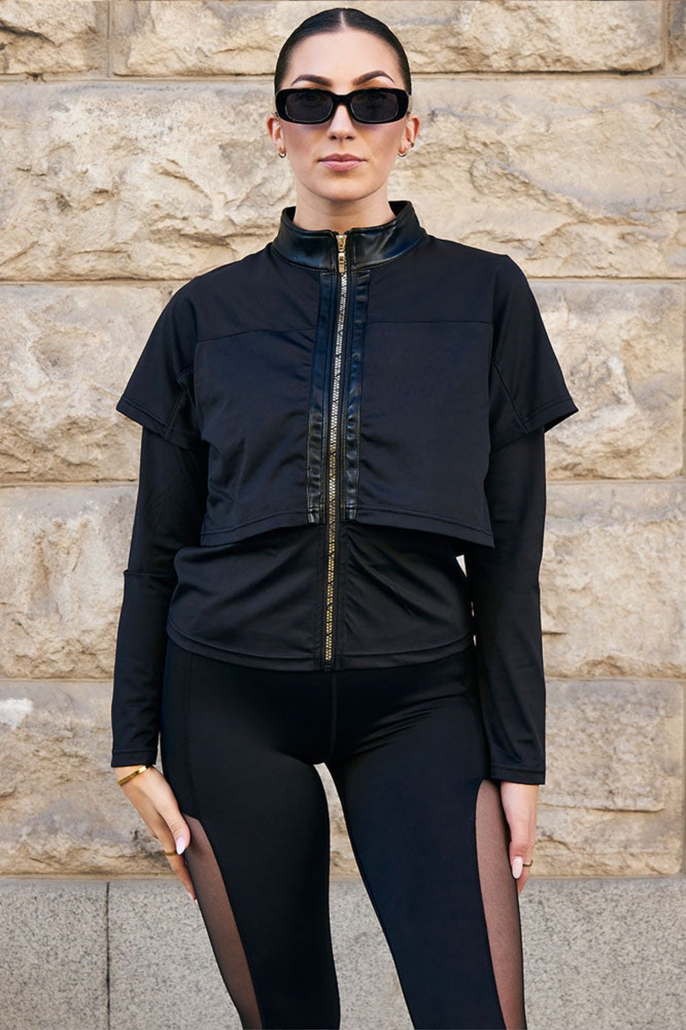 Edge training jacket Gold Zip with a gold-toned zip straight down the front, worn with black leggings with mesh.