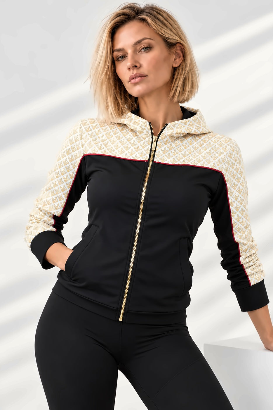 Yoke Training Jacket in black with a hood and yoke in gold and off-white, red piping and a gold-coloured zip.