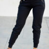 Black sweat pants with gold zipper pockets